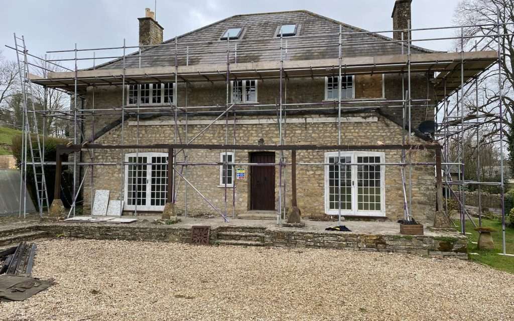 Large Detatched House With Scaffolding For Roof Repair